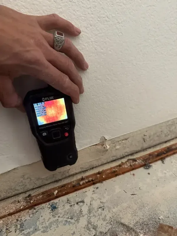 Thermal camera checking a wall where the baseboard came off